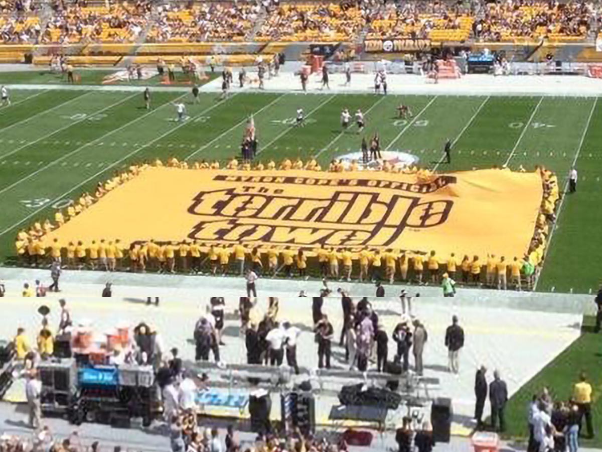 giant field flag banner held by over 100 people